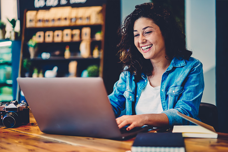 Stock-Image-Woman-Laughing-at-Computer Stock-Image-Woman-Laughing-at-Computer