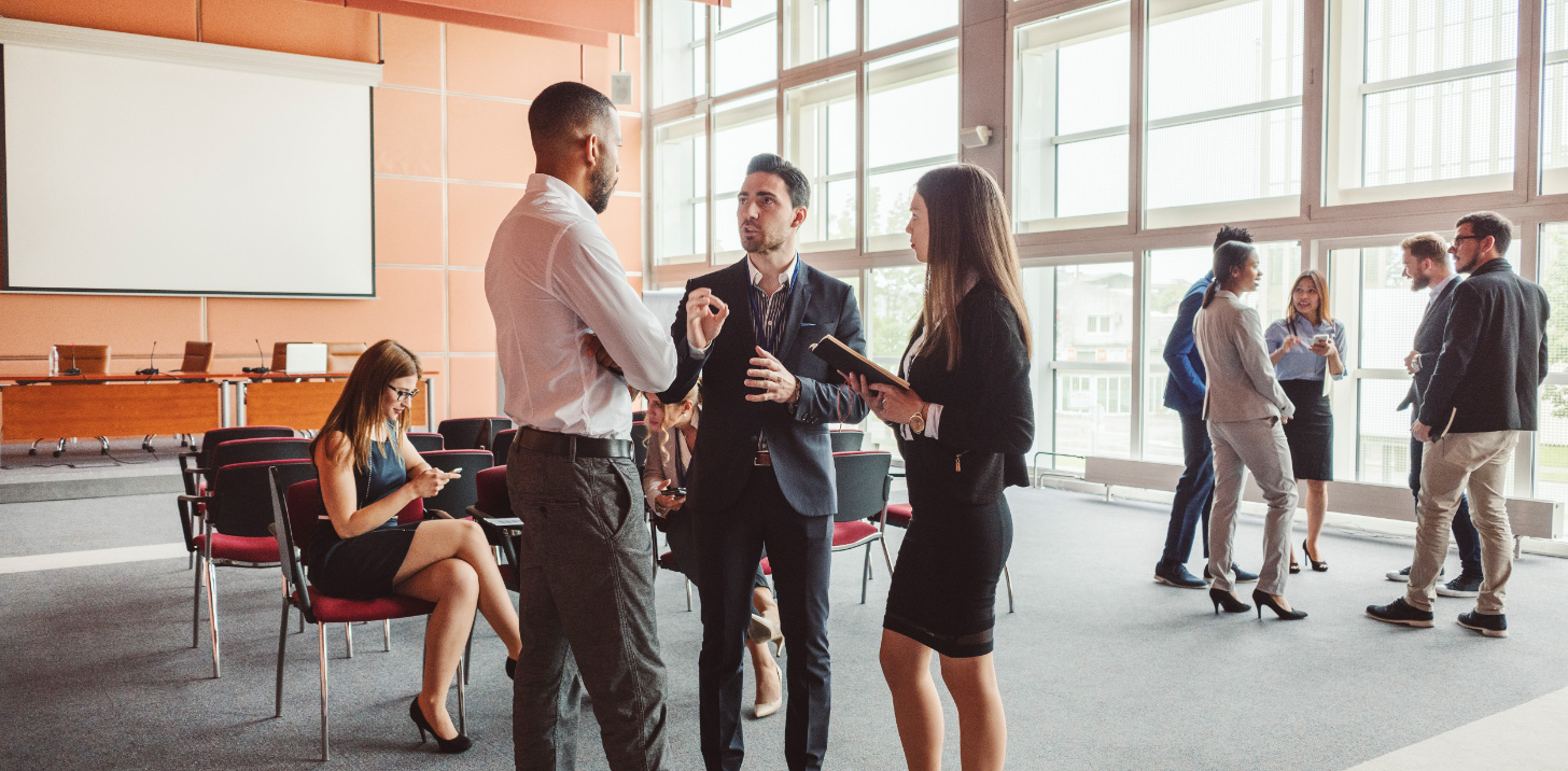 Young professionals talking to each other | AVIXA Young professionals talking to each other | AVIXA