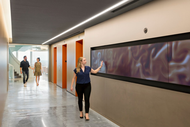 Woman walking through hall | AVIXA Woman walking through hall | AVIXA